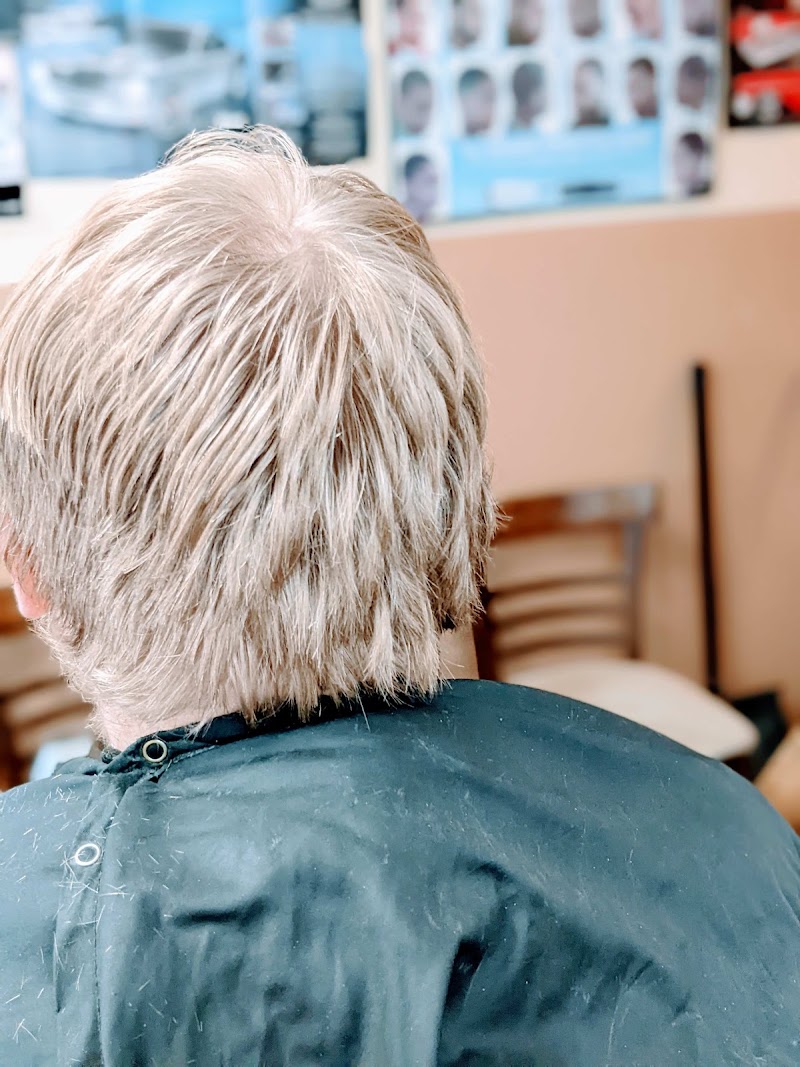 Client enjoying a haircut at ChynaStormm's Unisex Barbershop